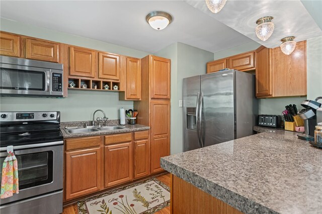1332 Rte 519, North Strabane, PA 15330 - kitchen with appliances with stainless steel finishes, a sink, light wood-style flooring, and brown cabinets