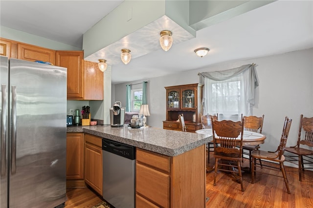 1332 Rte 519, North Strabane, PA 15330 - kitchen with appliances with stainless steel finishes, a peninsula, wood finished floors, and brown cabinetry