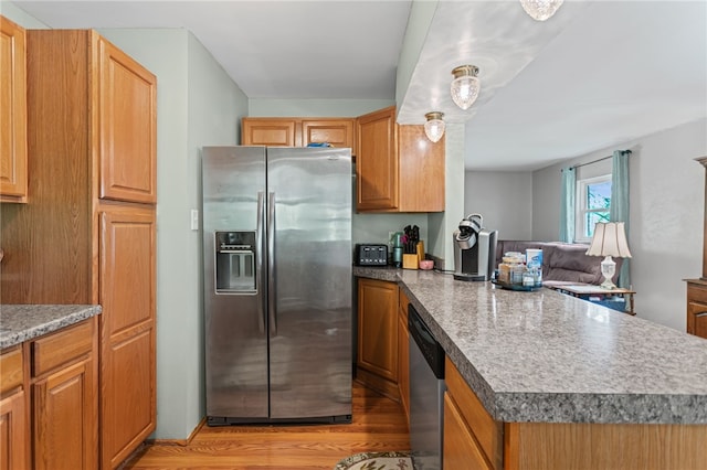 1332 Rte 519, North Strabane, PA 15330 - kitchen featuring stainless steel appliances, a peninsula, light wood-style floors, brown cabinetry, and open floor plan