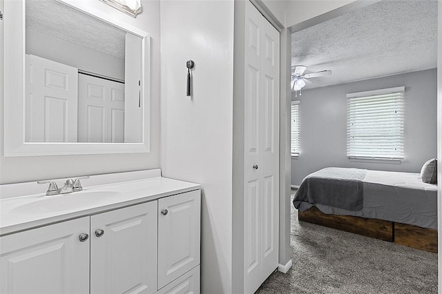 121 Woodhaven Dr, Seven Fields Boro, PA 16046 - ensuite bathroom with a textured ceiling, a ceiling fan, vanity, and a closet
