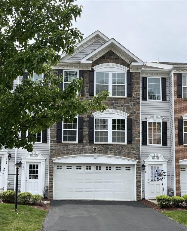 259 Grace Manor Dr, Robinson Twp Nwa, PA 15108 - multi unit property with stone siding, asphalt driveway, and an attached garage