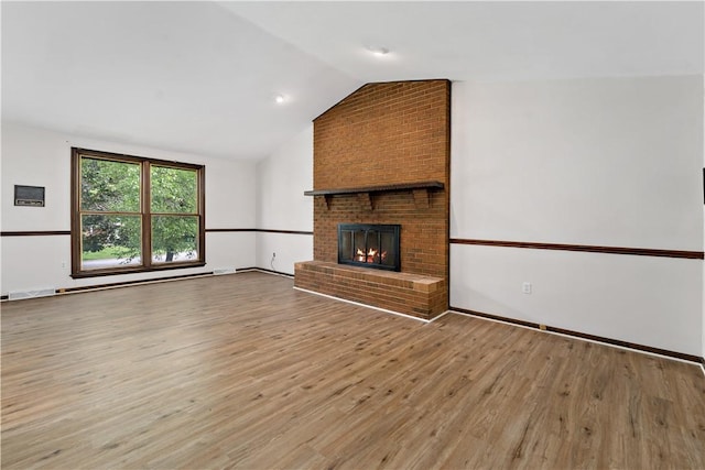 4117 Kellington Ct, Murrysville, PA 15668 - unfurnished living room with lofted ceiling, light wood-style flooring, a fireplace, and a baseboard heating unit