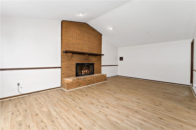 4117 Kellington Ct, Murrysville, PA 15668 - unfurnished living room featuring lofted ceiling, light wood-style floors, and a brick fireplace