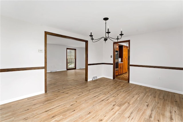 4117 Kellington Ct, Murrysville, PA 15668 - empty room featuring a chandelier and light wood finished floors