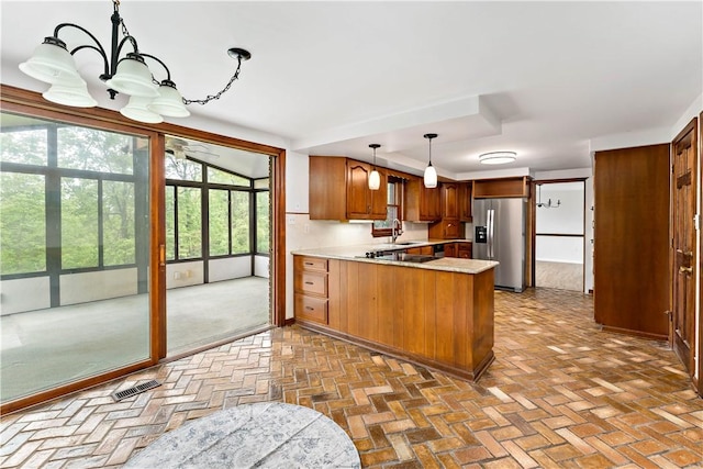 4117 Kellington Ct, Murrysville, PA 15668 - kitchen with stainless steel fridge, a peninsula, brick flooring, and a chandelier