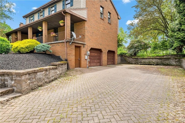 4117 Kellington Ct, Murrysville, PA 15668 - view of side of property featuring brick siding, decorative driveway, and an attached garage