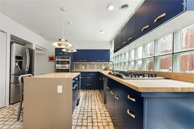 2219 Beechwood Blvd, Squirrel Hill, PA 15217 - kitchen with stainless steel appliances, blue cabinetry, a sink, decorative backsplash, and butcher block counters