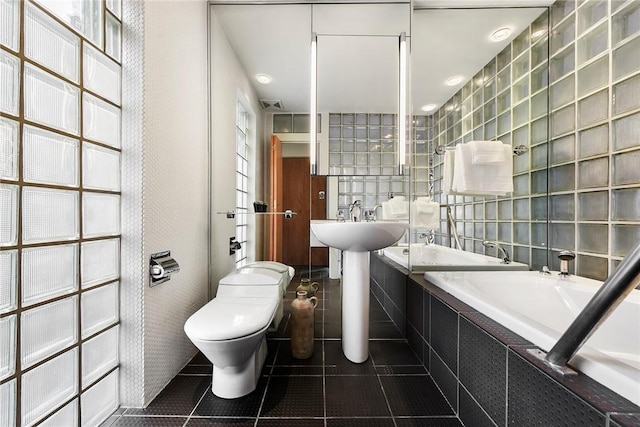 2219 Beechwood Blvd, Squirrel Hill, PA 15217 - bathroom featuring tile patterned flooring, a relaxing tiled tub, toilet, and tile walls
