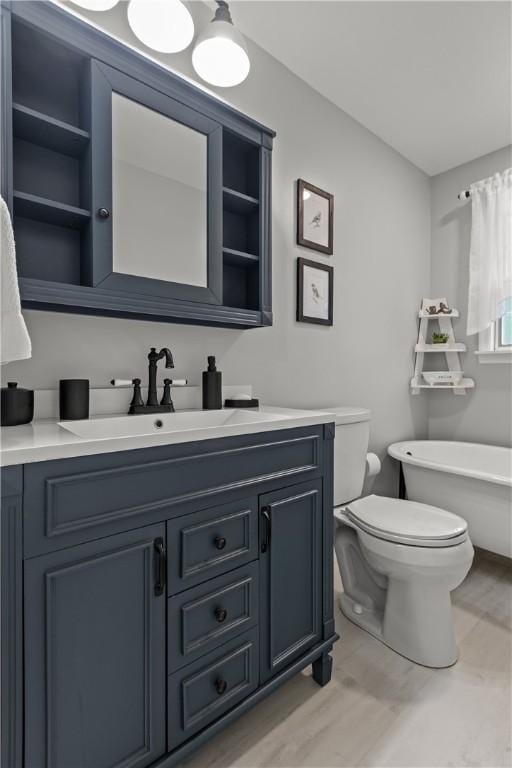 1509 Ingomar Heights Rd, Franklin Park, PA 15237 - full bath with vanity, a soaking tub, toilet, and wood finished floors