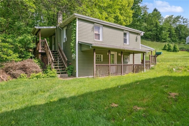 914 Western Ave, Jeannette, PA 15644 - view of front of house with a chimney, stairs, covered porch, and a front yard