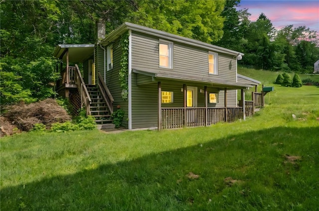 914 Western Ave, Jeannette, PA 15644 - view of front of house featuring a porch, a chimney, stairway, and a front lawn