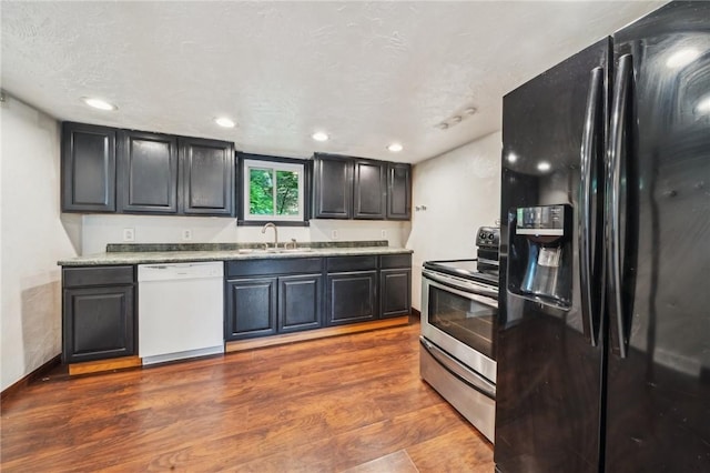 914 Western Ave, Jeannette, PA 15644 - kitchen with black fridge with ice dispenser, dishwasher, stainless steel electric range oven, a sink, and dark wood-style floors