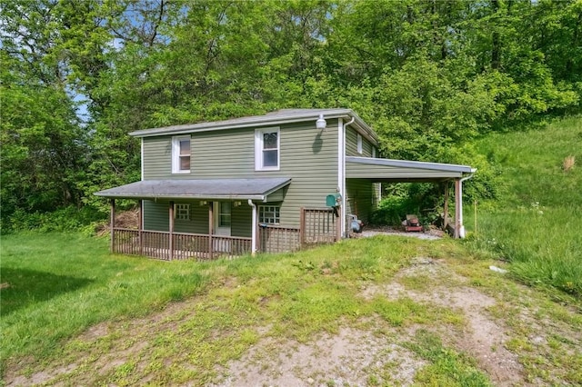 914 Western Ave, Jeannette, PA 15644 - view of front of property featuring dirt driveway, a carport, and a porch