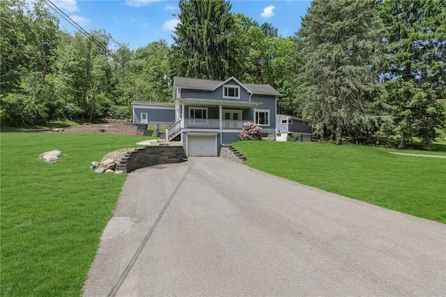 9895 Willow Dr, Mccandless, PA 15090 - view of front facade featuring stairs, asphalt driveway, a porch, an attached garage, and a front yard