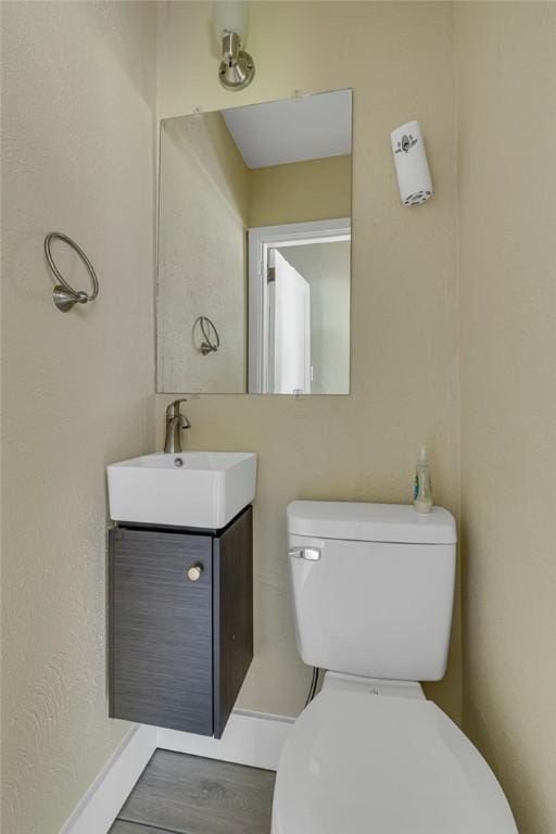 9895 Willow Dr, Mccandless, PA 15090 - bathroom featuring vanity, toilet, baseboards, and wood finished floors