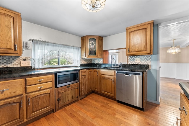 271 Harbison Rd, Buffalo Twp But, PA 16055 - kitchen featuring stainless steel appliances, a sink, brown cabinets, light wood finished floors, and wainscoting