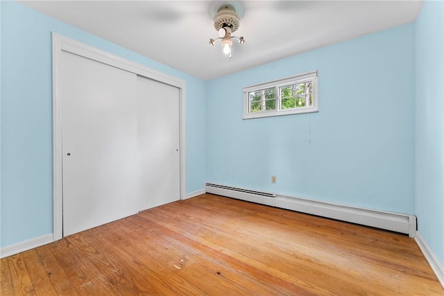 271 Harbison Rd, Buffalo Twp But, PA 16055 - unfurnished bedroom with a baseboard radiator, a closet, and wood finished floors