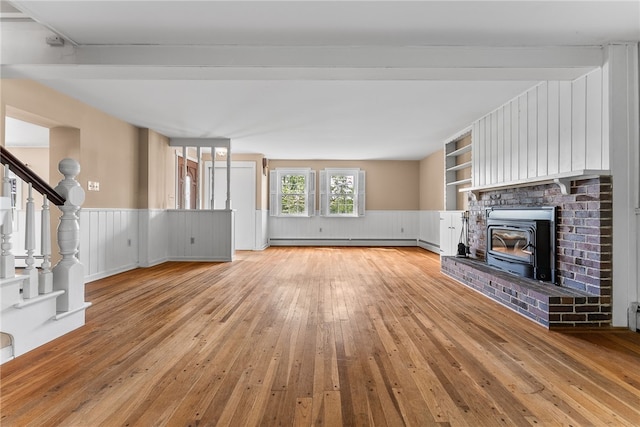 271 Harbison Rd, Buffalo Twp But, PA 16055 - unfurnished living room with baseboard heating, light wood-style flooring, wainscoting, stairway, and a decorative wall