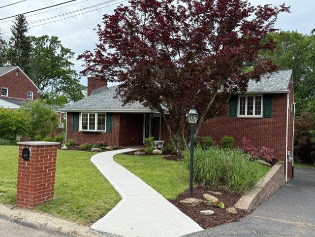 2612 Saybrook Dr, Churchill Boro, PA 15235 - view of front of home featuring brick siding, a front yard, and a chimney