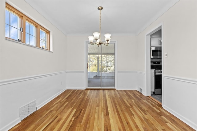 2612 Saybrook Dr, Churchill Boro, PA 15235 - unfurnished dining area with a chandelier, healthy amount of natural light, light wood-type flooring, and baseboards