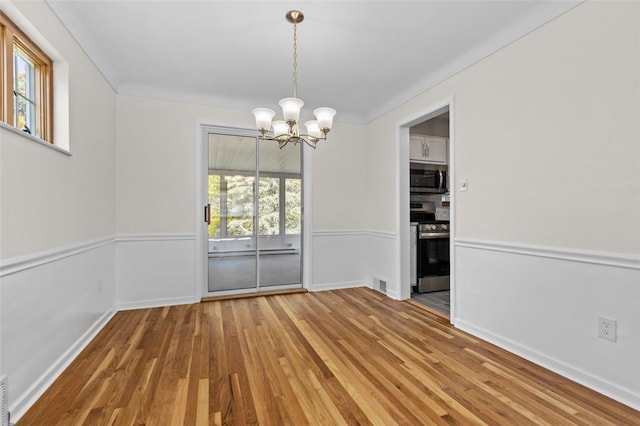 2612 Saybrook Dr, Churchill Boro, PA 15235 - unfurnished dining area with wood finished floors, a chandelier, baseboards, and ornamental molding