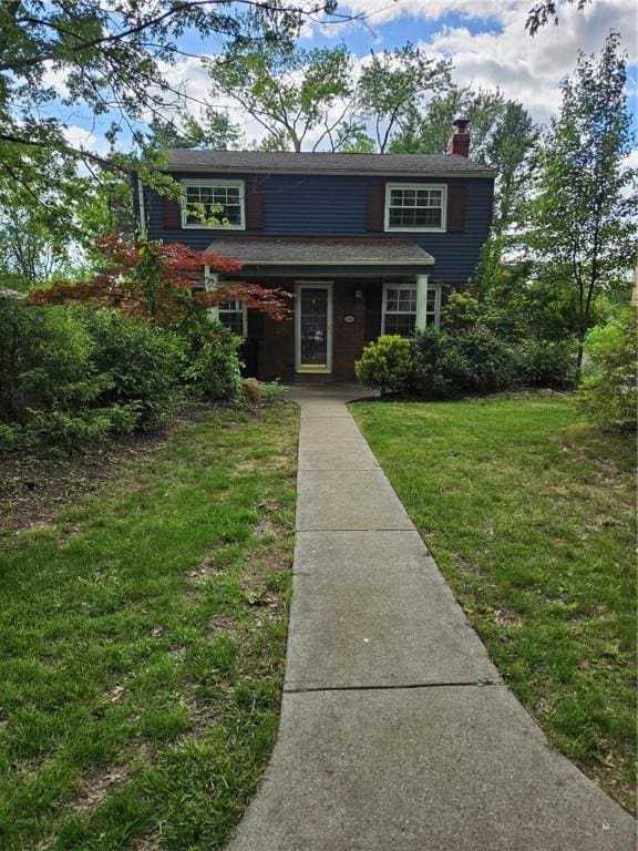 227 Ridge Ave, Forest Hills Boro, PA 15221 - view of front facade with a front yard and a chimney