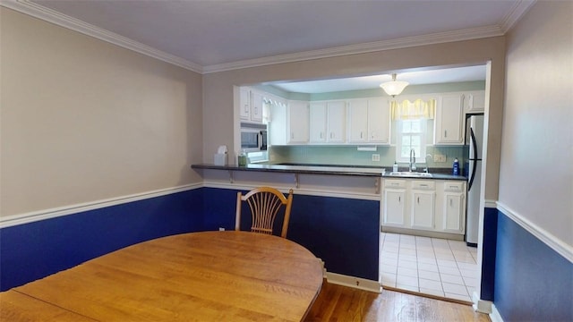 227 Ridge Ave, Forest Hills Boro, PA 15221 - kitchen with appliances with stainless steel finishes, a sink, white cabinets, dark countertops, and light wood-style flooring