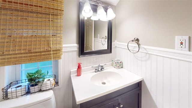 227 Ridge Ave, Forest Hills Boro, PA 15221 - bathroom featuring vanity, toilet, a wainscoted wall, and a decorative wall