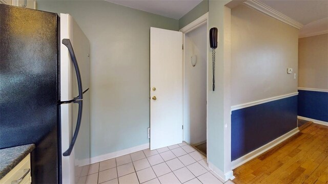 227 Ridge Ave, Forest Hills Boro, PA 15221 - kitchen with freestanding refrigerator, ornamental molding, baseboards, dark countertops, and light wood finished floors