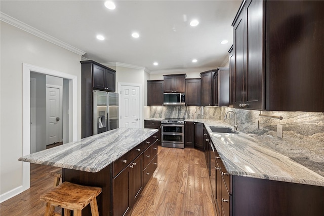 821 Westminster Ln, Cranberry Twp, PA 16066 - kitchen with appliances with stainless steel finishes, a sink, a center island, crown molding, and light wood-type flooring