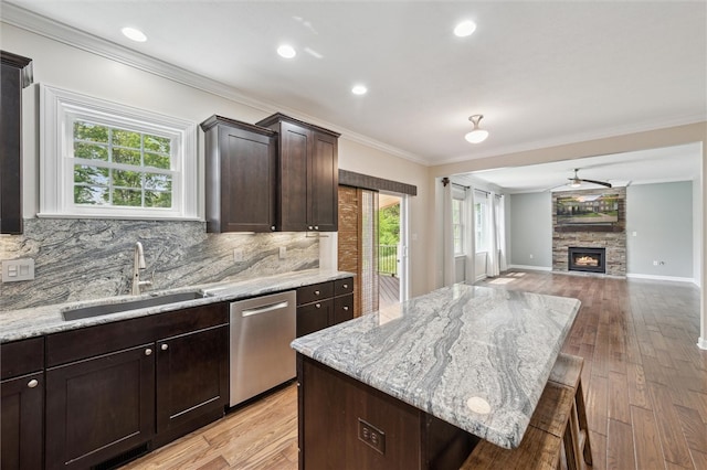 821 Westminster Ln, Cranberry Twp, PA 16066 - kitchen featuring a sink, stainless steel dishwasher, light wood finished floors, ornamental molding, and a center island