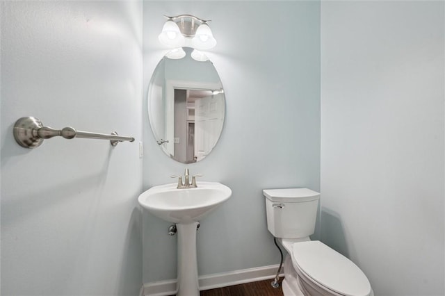 821 Westminster Ln, Cranberry Twp, PA 16066 - bathroom with toilet, wood finished floors, baseboards, and a sink