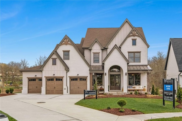 205 Rothaar Ct, Peters Twp, PA 15367 - view of front of property with board and batten siding, a front lawn, driveway, an attached garage, and a shingled roof