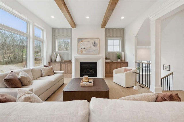 205 Rothaar Ct, Peters Twp, PA 15367 - living area with healthy amount of natural light, light wood-type flooring, beamed ceiling, a glass covered fireplace, and recessed lighting
