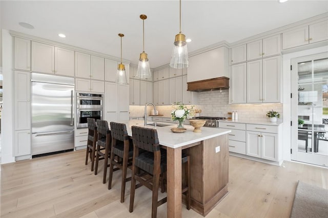 205 Rothaar Ct, Peters Twp, PA 15367 - kitchen featuring appliances with stainless steel finishes, light wood finished floors, decorative backsplash, recessed lighting, and light countertops