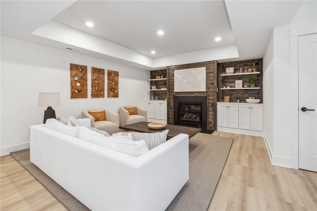 205 Rothaar Ct, Peters Twp, PA 15367 - living room with a raised ceiling, light wood-style flooring, baseboards, recessed lighting, and a large fireplace