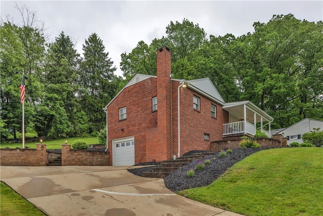 360 Orr Ave, Allegheny Twp, PA 15613 - view of side of home featuring driveway, an attached garage, a chimney, and a lawn