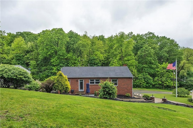 360 Orr Ave, Allegheny Twp, PA 15613 - view of front of property with a front lawn, brick siding, and a wooded view