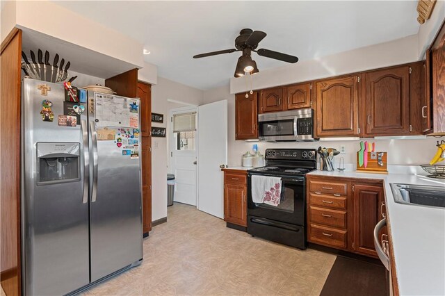 2092 Arnold Acres Dr, Banksville/Westwood, PA 15205 - kitchen featuring stainless steel appliances, a ceiling fan, light countertops, a sink, and light floors