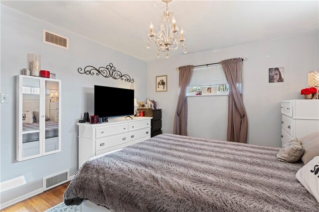 2092 Arnold Acres Dr, Banksville/Westwood, PA 15205 - bedroom with a chandelier, wood finished floors, and baseboards