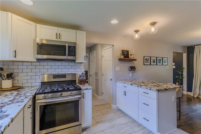 5125 Curry Rd, Baldwin Boro, PA 15236 - kitchen with stainless steel appliances, light stone counters, white cabinetry, tasteful backsplash, and recessed lighting