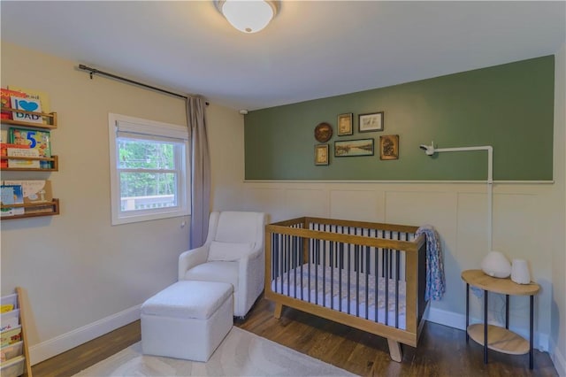 5125 Curry Rd, Baldwin Boro, PA 15236 - bedroom featuring wood finished floors, a crib, and wainscoting