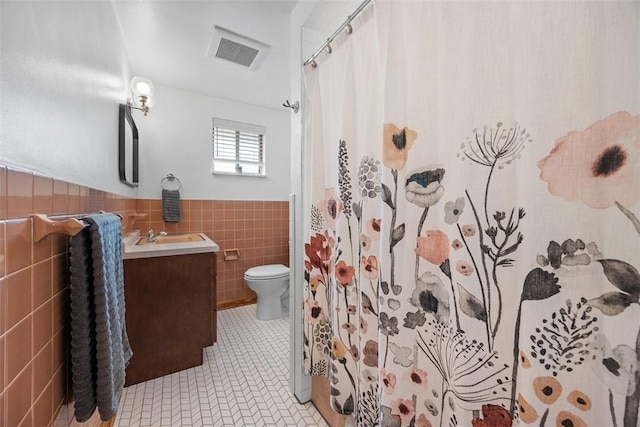 1111 Oriole Dr, Green Tree, PA 15220 - full bath with tile walls, a wainscoted wall, vanity, toilet, and tile patterned flooring