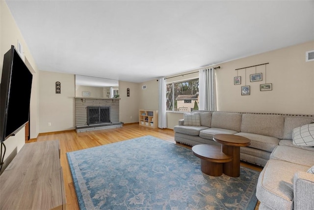 1111 Oriole Dr, Green Tree, PA 15220 - living area featuring light wood-style floors, a brick fireplace, and baseboards
