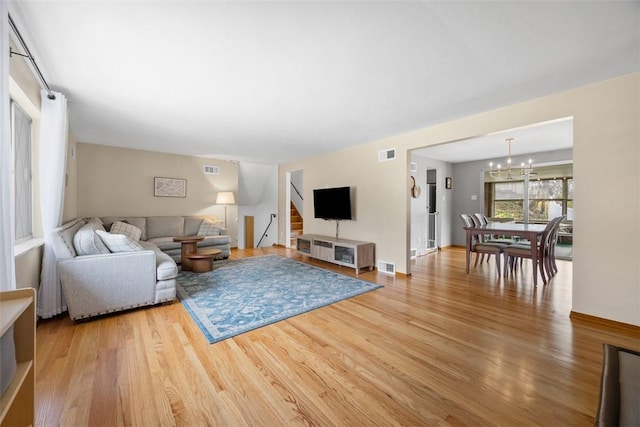 1111 Oriole Dr, Green Tree, PA 15220 - living area with a chandelier, light wood finished floors, and stairs