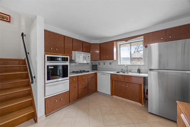 1111 Oriole Dr, Green Tree, PA 15220 - kitchen with stainless steel appliances, a warming drawer, a sink, tasteful backsplash, and light countertops
