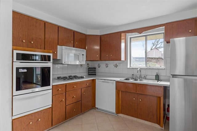 1111 Oriole Dr, Green Tree, PA 15220 - kitchen with white appliances, a warming drawer, a sink, tasteful backsplash, and light countertops