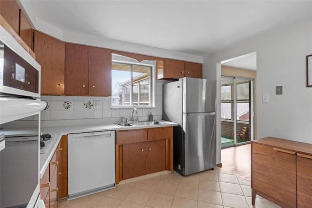 1111 Oriole Dr, Green Tree, PA 15220 - kitchen with white dishwasher, freestanding refrigerator, a sink, and healthy amount of natural light