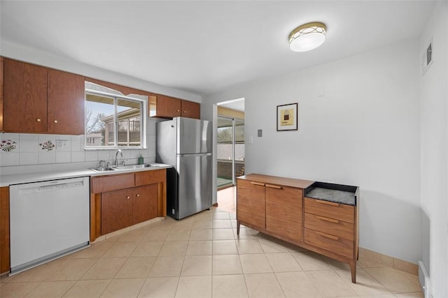 1111 Oriole Dr, Green Tree, PA 15220 - kitchen with dishwasher, freestanding refrigerator, a sink, and healthy amount of natural light