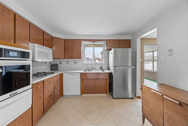 1111 Oriole Dr, Green Tree, PA 15220 - kitchen featuring appliances with stainless steel finishes, a warming drawer, a sink, backsplash, and healthy amount of natural light